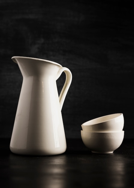 Free photo minimalist small white cups and jug