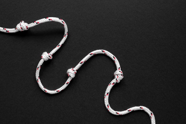 Free photo minimalist white sailor rope knot on black background