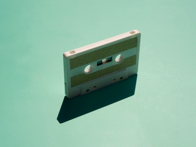 Minimalistic cessette tape under spotlight with its shadow