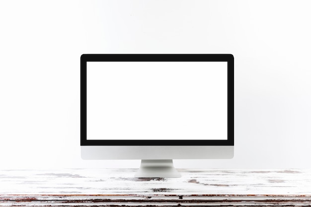 Free photo minimalistic monitor on wooden table