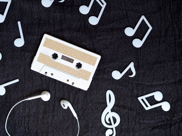 Minimalistic white cassette tape wit musical notes around