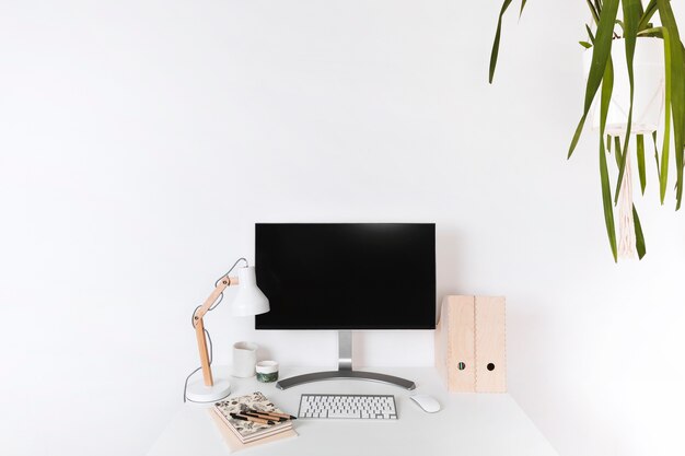 Minimalistic wooden workplace with blank monitor