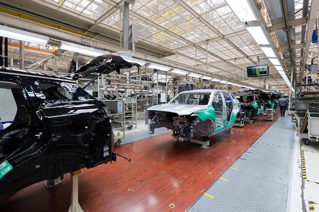 Free photo minsk belarus dec 15 2021 car bodies are on assembly line factory for production of cars modern automotive industry a car being checked before being painted in a hightech enterprise