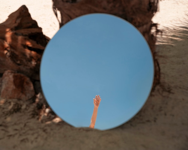 Free photo mirror background with hands outdoors