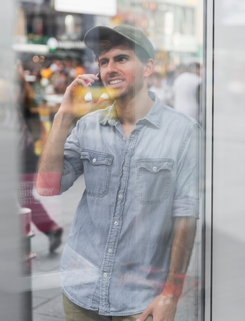 Free photo mirroring image man talking at phone