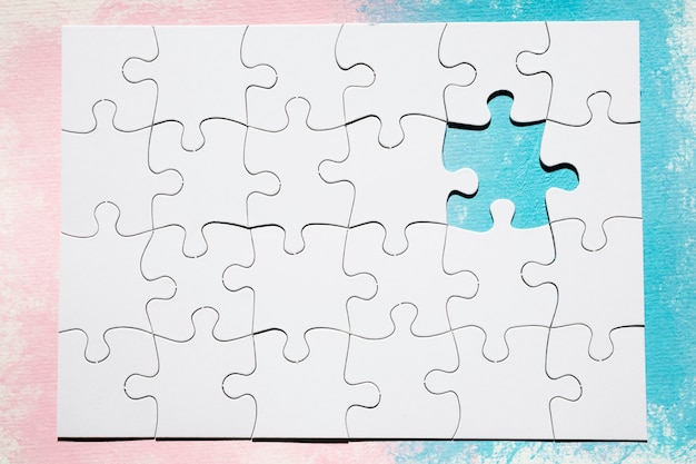 Missing piece of white puzzle over dual colored surface