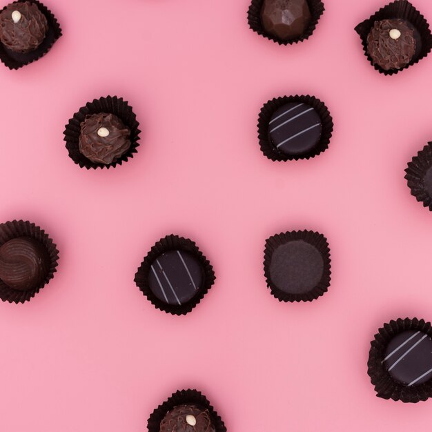 Mix of chocolates on pink background