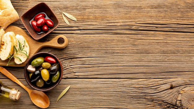 Mix of olives in bowls and bread with copy space