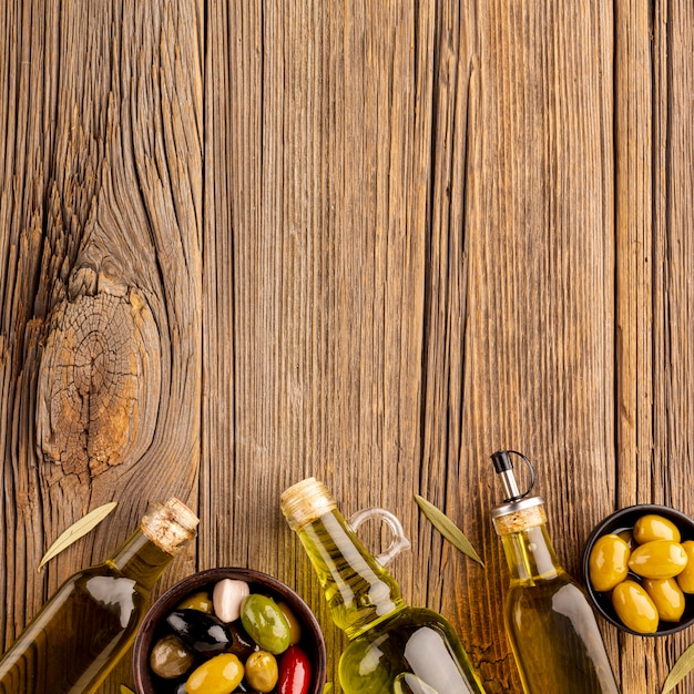 Mix of olives in bowls and olive oil bottles with copy space