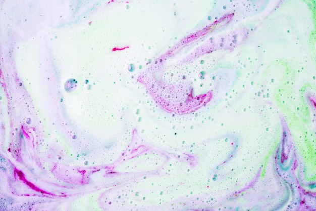 Free photo mixed colored bath bombs in water