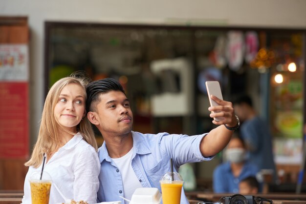 Mixed couple taking selfie