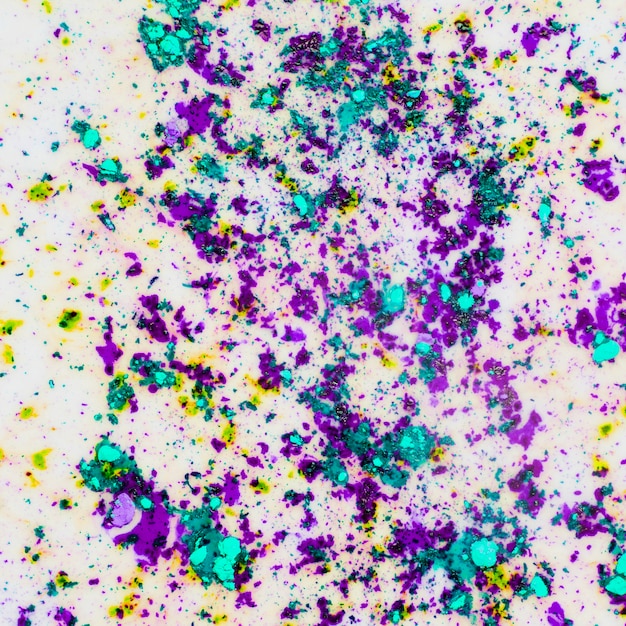 Free photo mixed holi color powder splatter on white backdrop