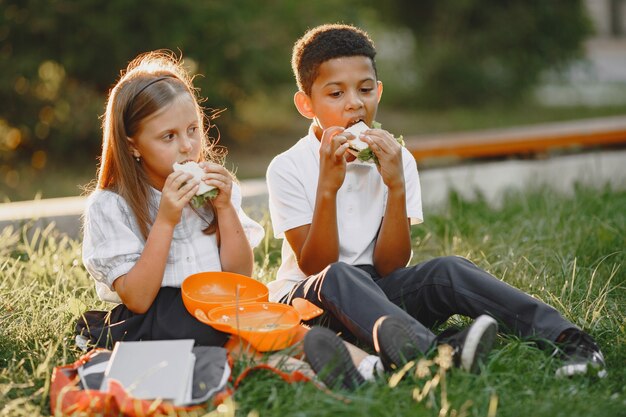 Mixed-races boy and little girl in park