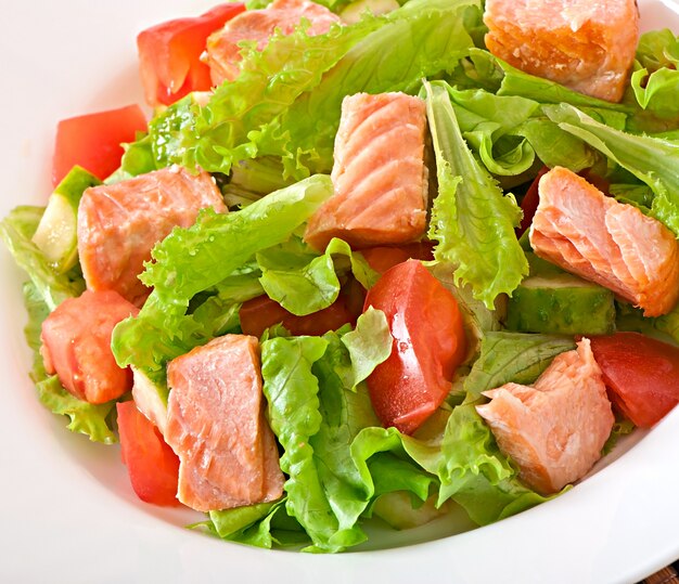 Mixed salad of fresh vegetables with pieces of salmon