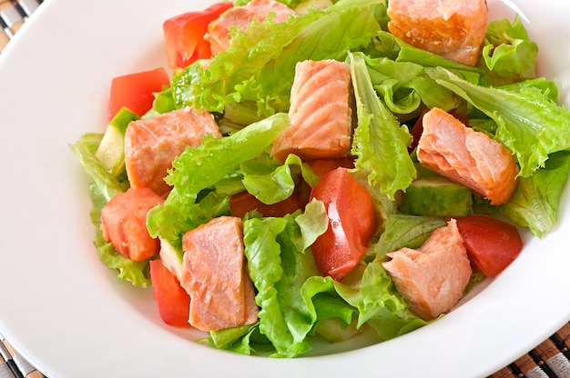 Mixed salad of fresh vegetables with pieces of salmon