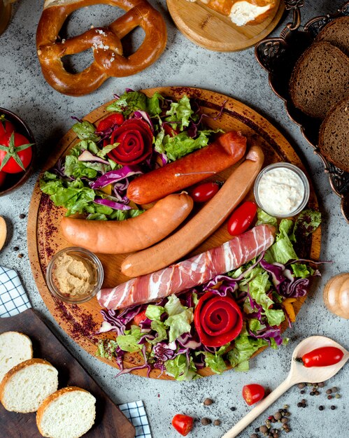 Mixed sausages on desk with bagel