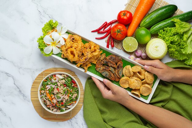 Mixed Spicy Salad with Vietnamese Sausage, Preserved Egg and Crispy Squid, Thai Food.