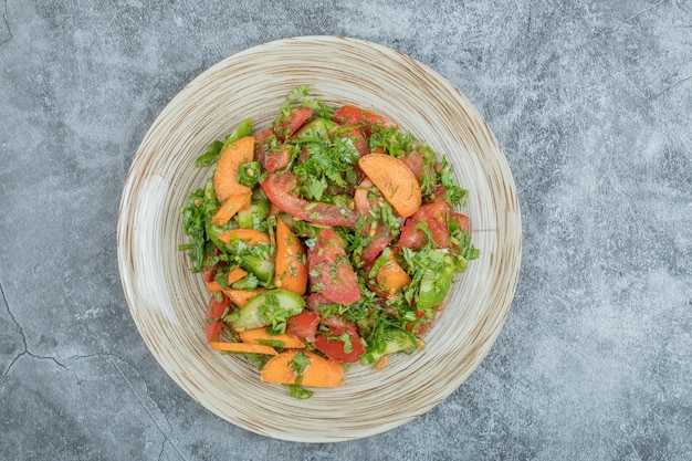 Mixed vegetable salad on ceramic plate. 