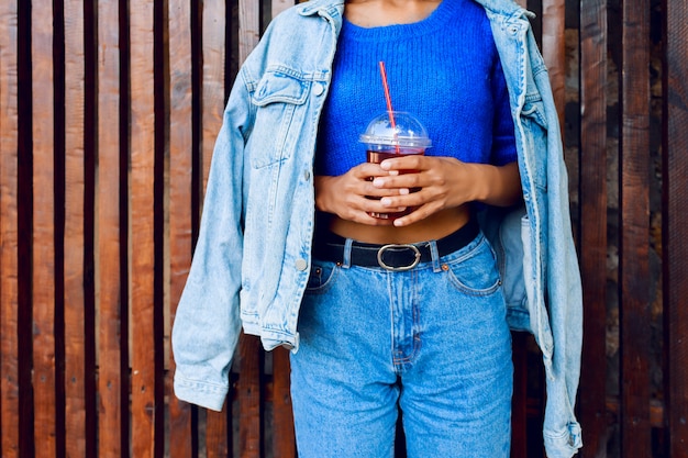 Mixed woman with hairs having fun , smiling , posing outdoor on wood urban wall.