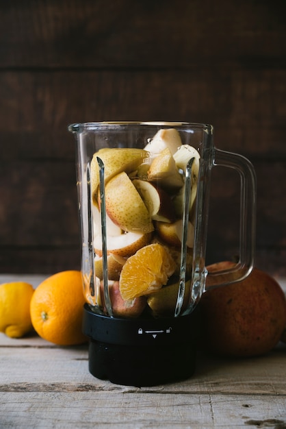 Free Photo mixer full of fruit mix on wooden table