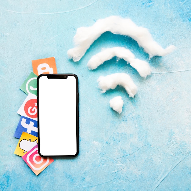 Free photo mobile phone and vivid social media icon beside wi-fi symbol made of cotton wool