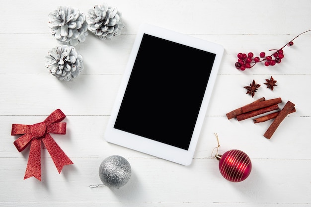 Mock up blank empty screen of tablet on the white wooden table