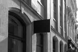 Free photo mockup of a street sign on a classic black and white building