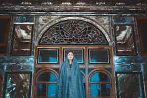 Free photo model in blue dress in a historical mosque