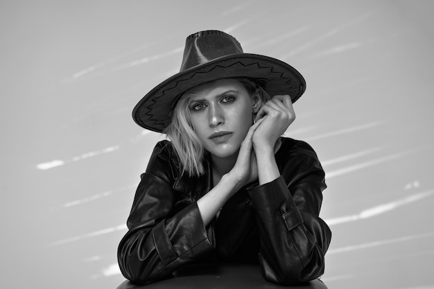 Free Photo model posing with hat black and white medium shot