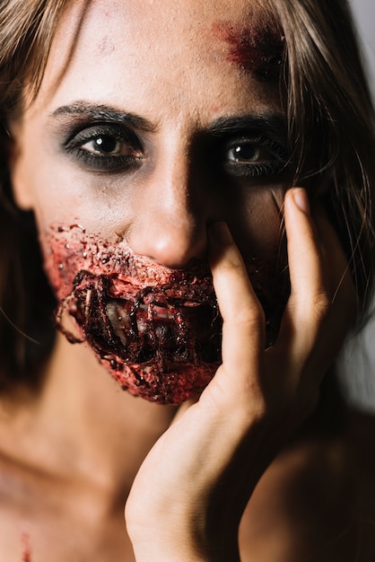 Free Photo model with halloween makeup touching face