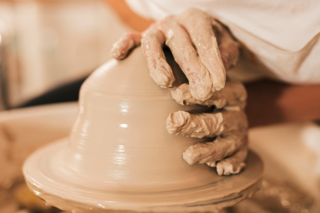 Free photo modeling of clay on a potter's wheel in the pottery workshop