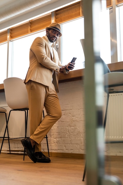 Free photo modern african american man in beige suit