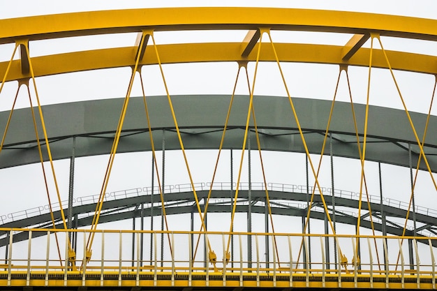 Free photo modern bridge with yellow and grey metal fragments