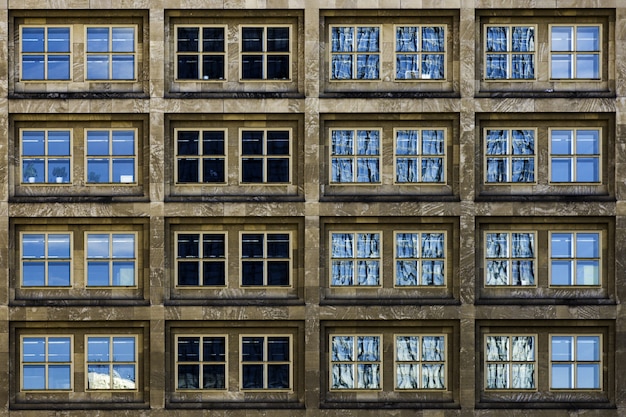 Modern building with glass windows silently witnessing the life of the big city