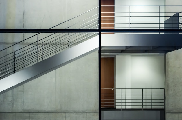 Modern building with glass windows and staircases under the lights