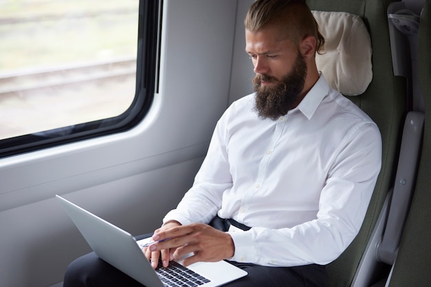 Free photo modern businessman working in the train