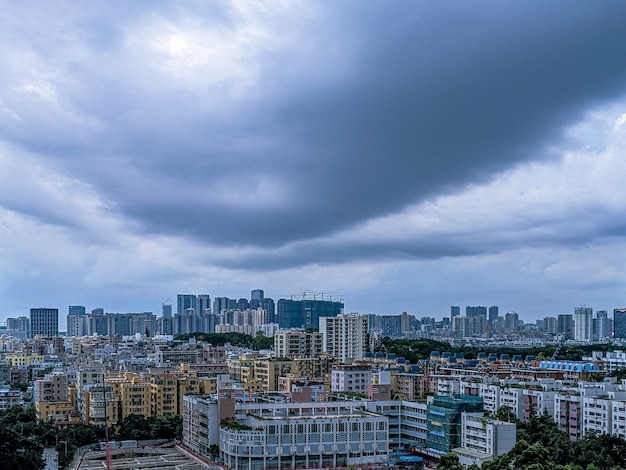 Modern city and a sky full of dark clouds