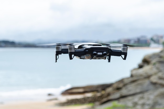 Free Photo modern drone flying over rocky seacoast