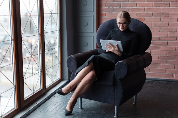 Free Photo modern female with tablet on couch