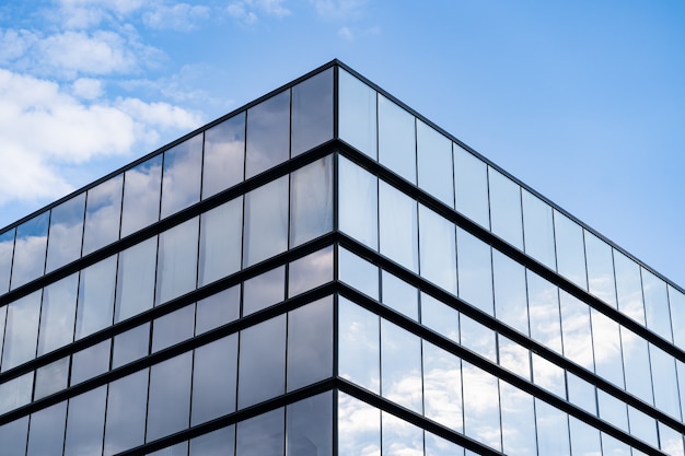 Modern Glass Building Architecture with blue sky and clouds