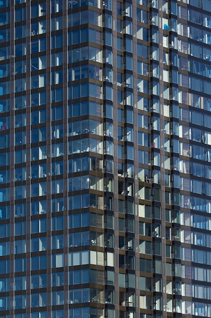 Free Photo modern glass skyscraper background with sky and clouds reflection