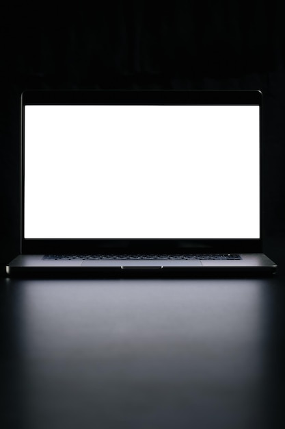 Free photo modern laptop with blank white screen isolated on black background close up