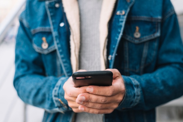 Modern man using smartphone in city