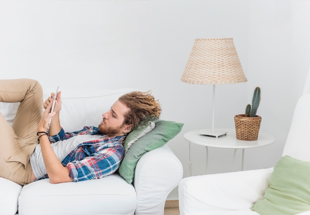 Modern man using table on couch