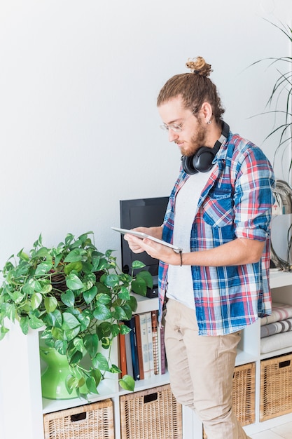 Modern man using tablet at home