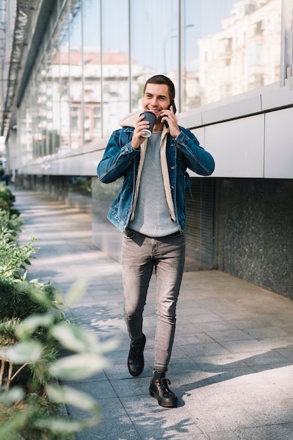 Free Photo modern man with coffee cup in urban environment