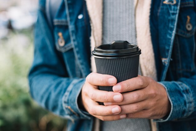 Modern man with coffee cup in urban environment