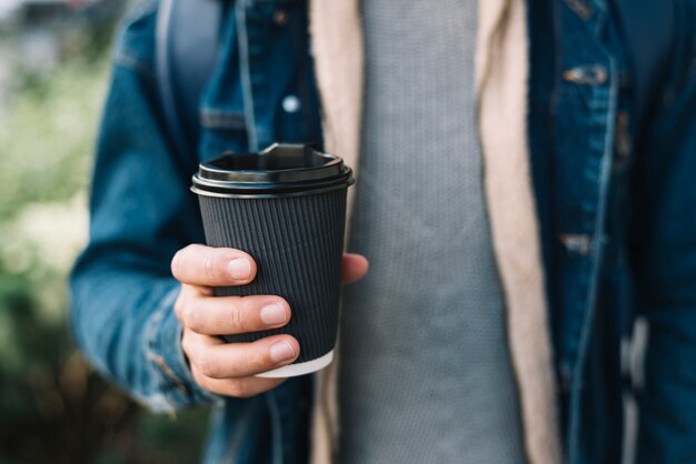 Free photo modern man with coffee cup in urban environment