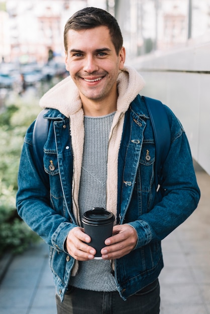 Free photo modern man with coffee cup in urban environment