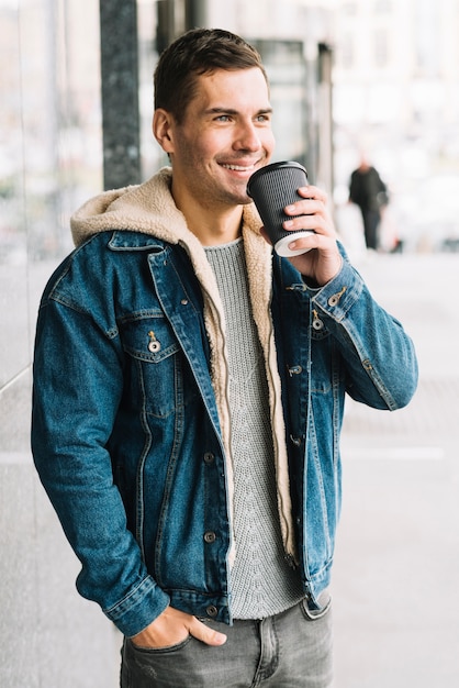 Free Photo modern man with coffee cup in urban environment